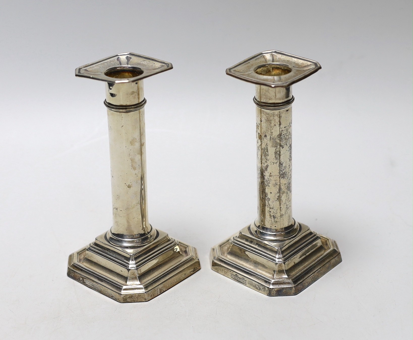 A pair of George V silver mounted dwarf candlesticks, James Dixon & Sons, Sheffield, 1913, 13.8cm, weighted.
